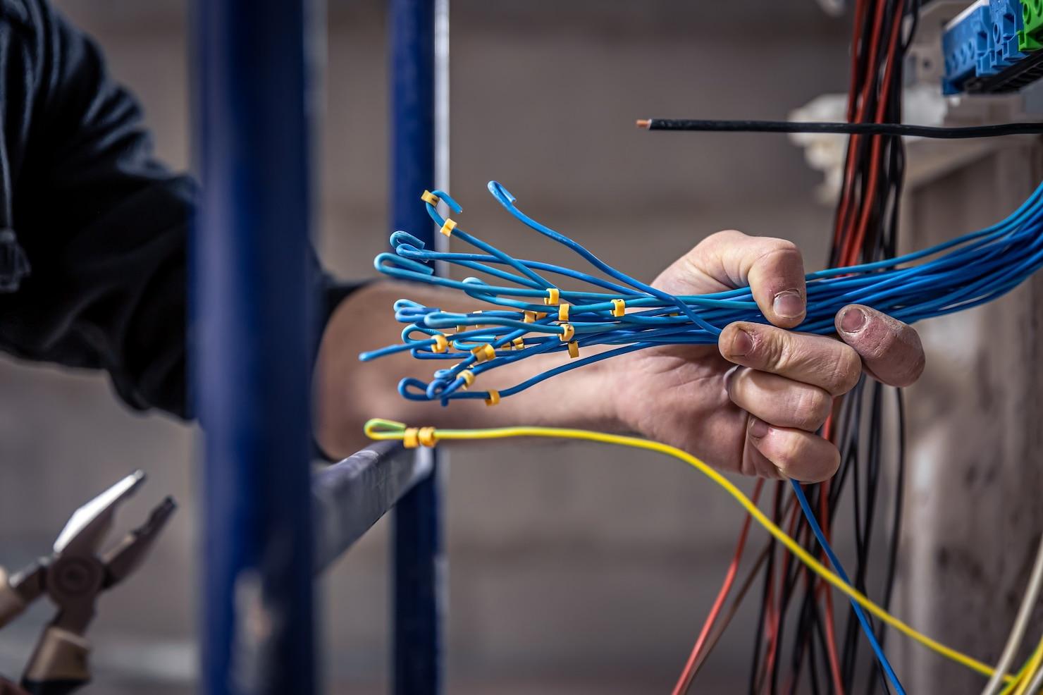 Electrician working on electrical connections for a commercial project in Pakistan